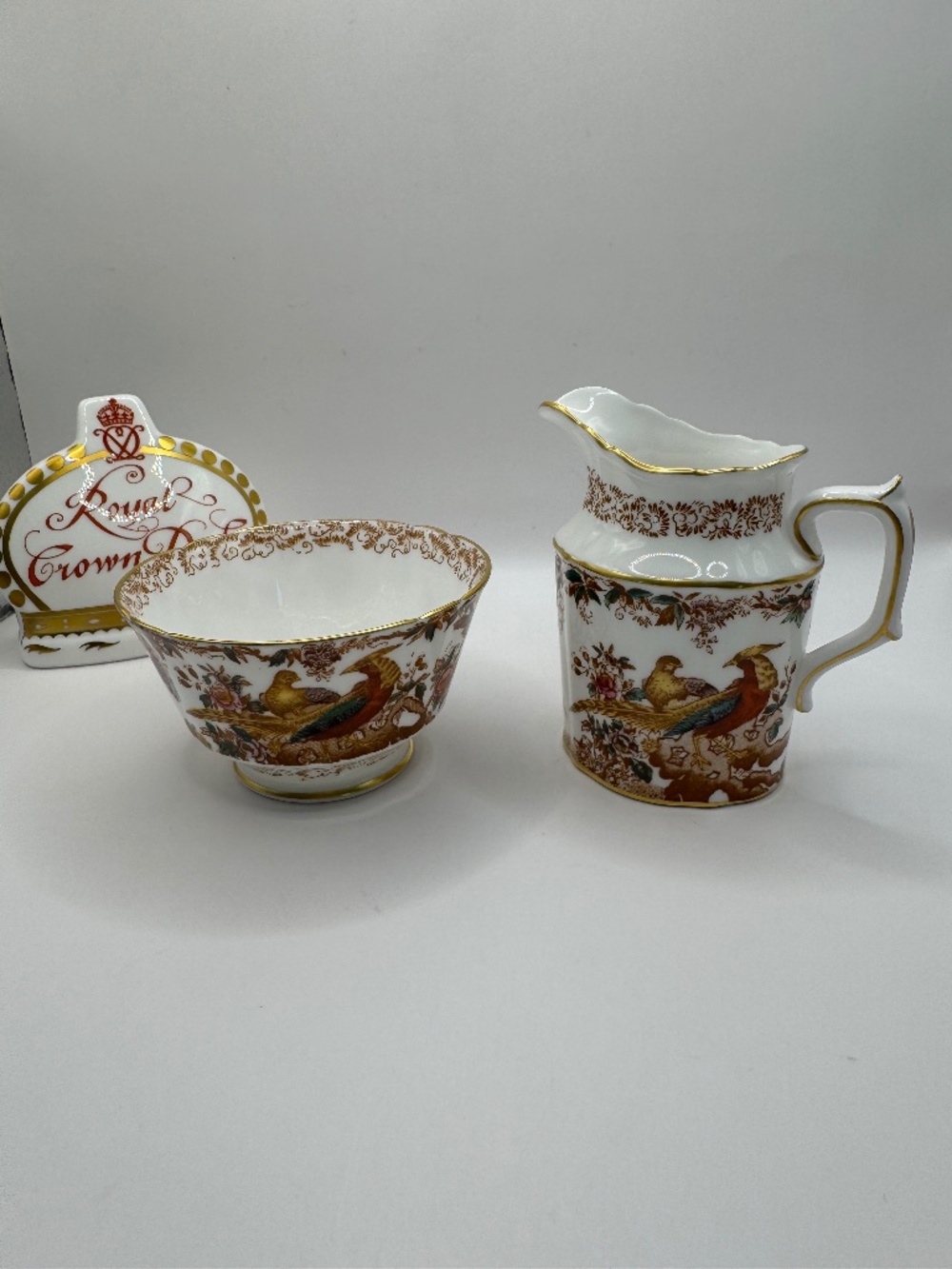 Royal Crown Derby Olde Avesbury Birds of Paradise open sugar and creamer set.